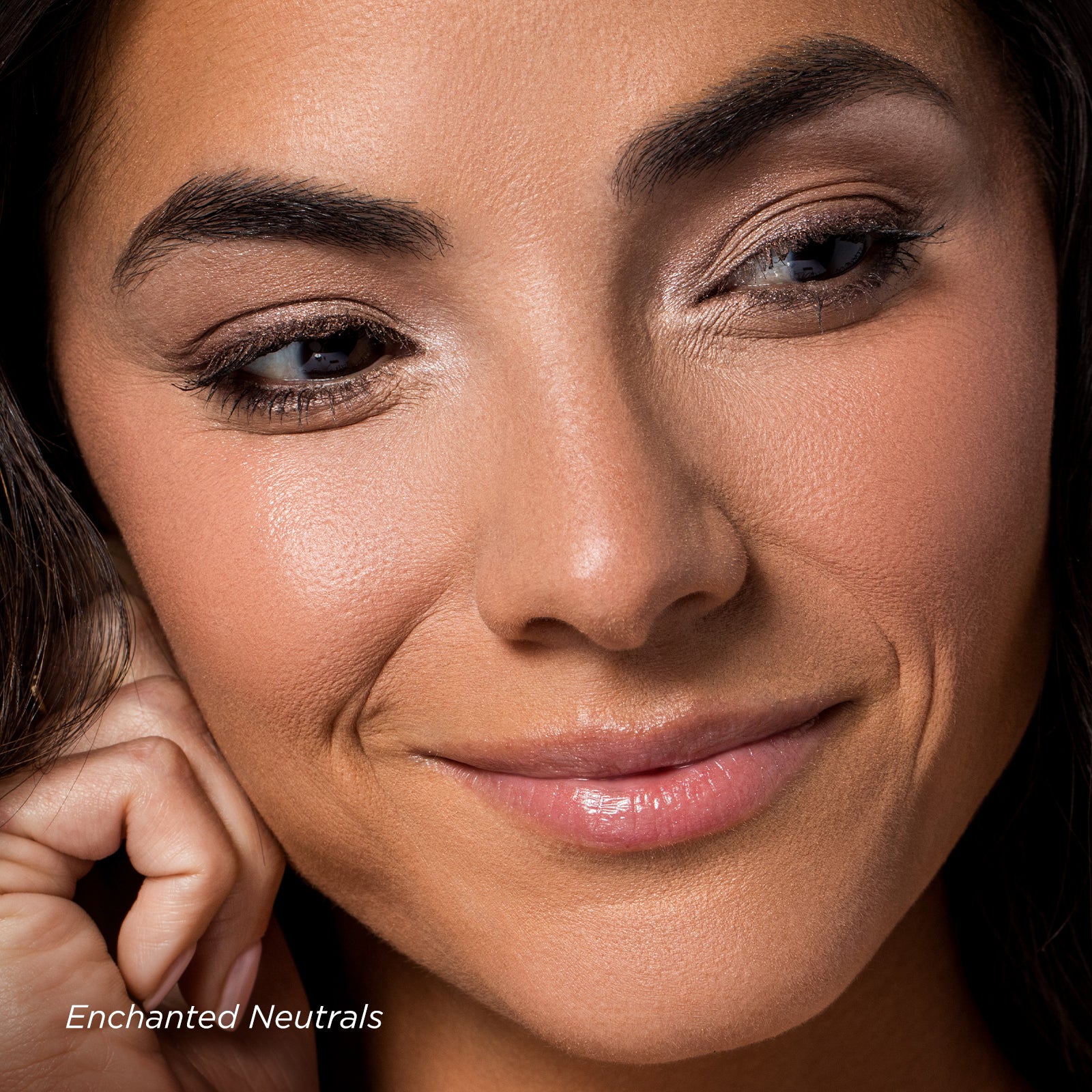 Close-up of a woman's face with 'Enchanted Neutrals' makeup theme.