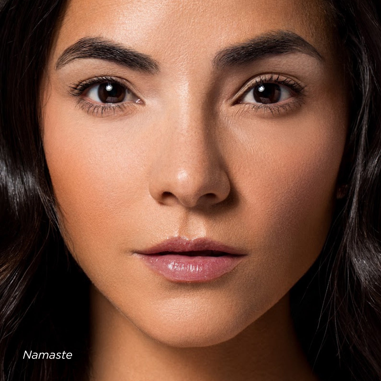 Close-up of a woman's face with 'Namaste' text at the bottom.