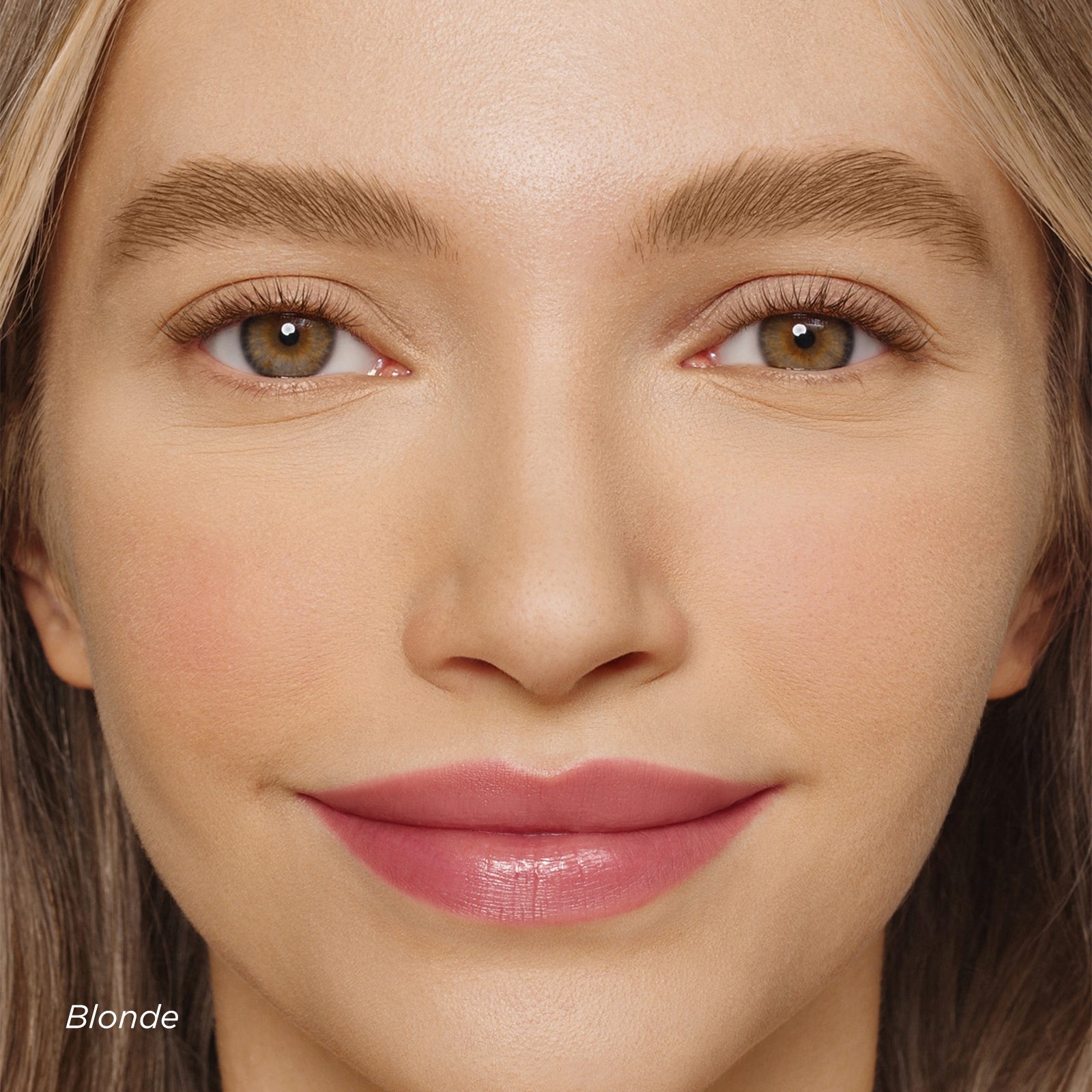 Close-up of a woman's face with blonde hair and pink lipstick.