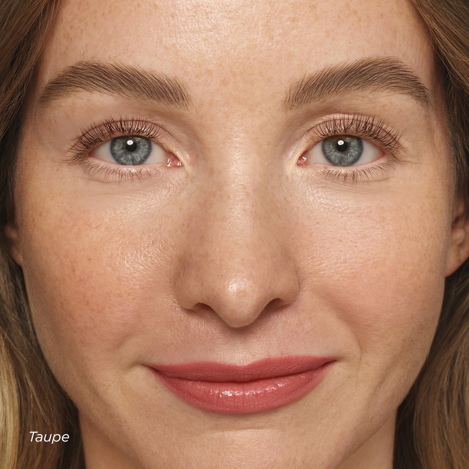 Close-up of a woman's face with a neutral expression, showing skin texture and color.