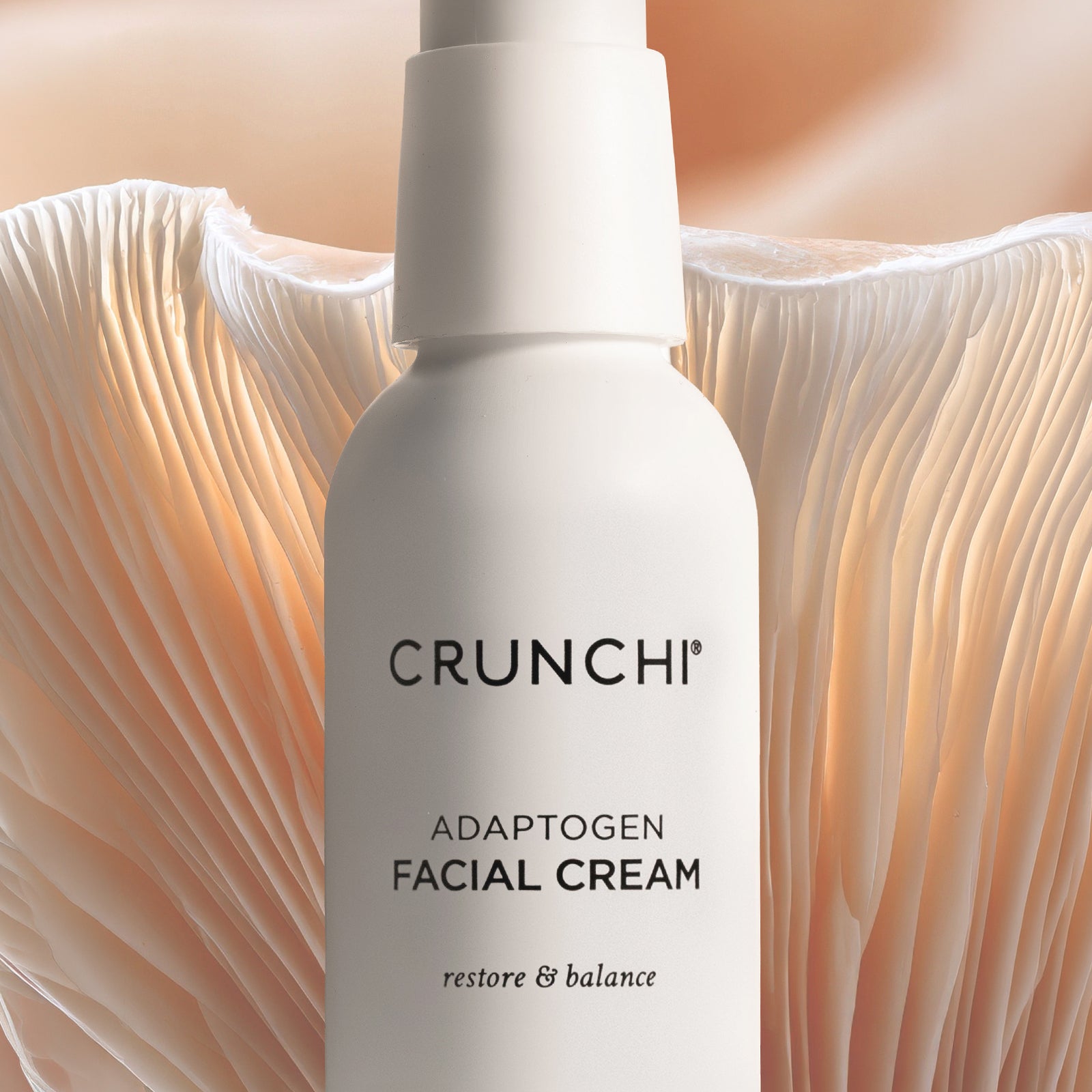 CRUNCHI adaptogen facial cream bottle on a soft, beige mushroom background