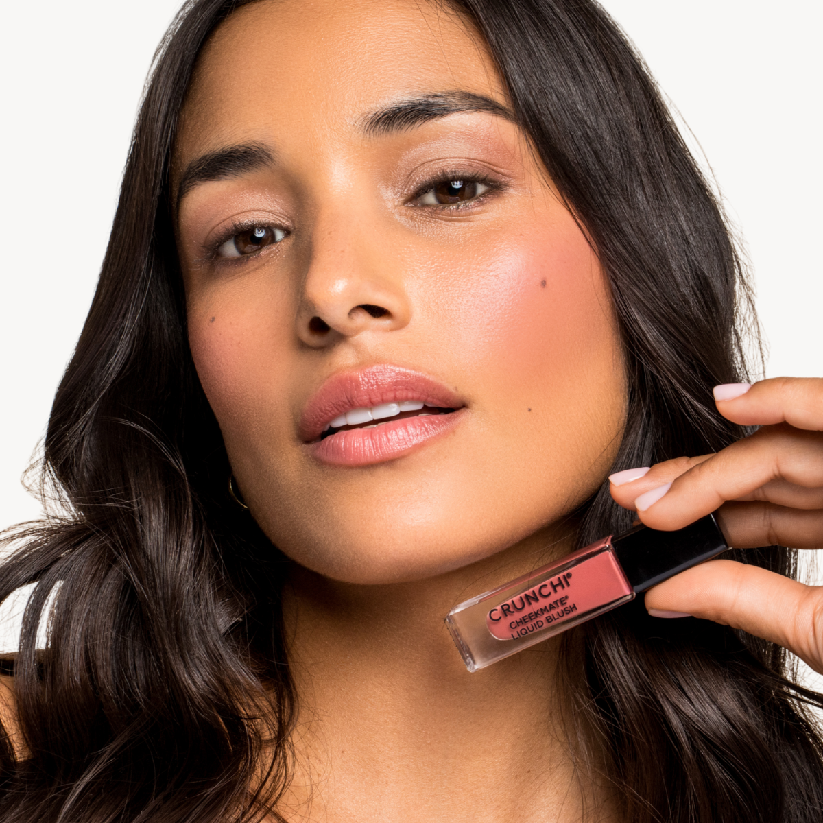 Woman holding a cheekmate with 'Crunchi' text against a neutral background